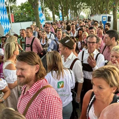 Event ticket in hand at a venue with colorful lighting